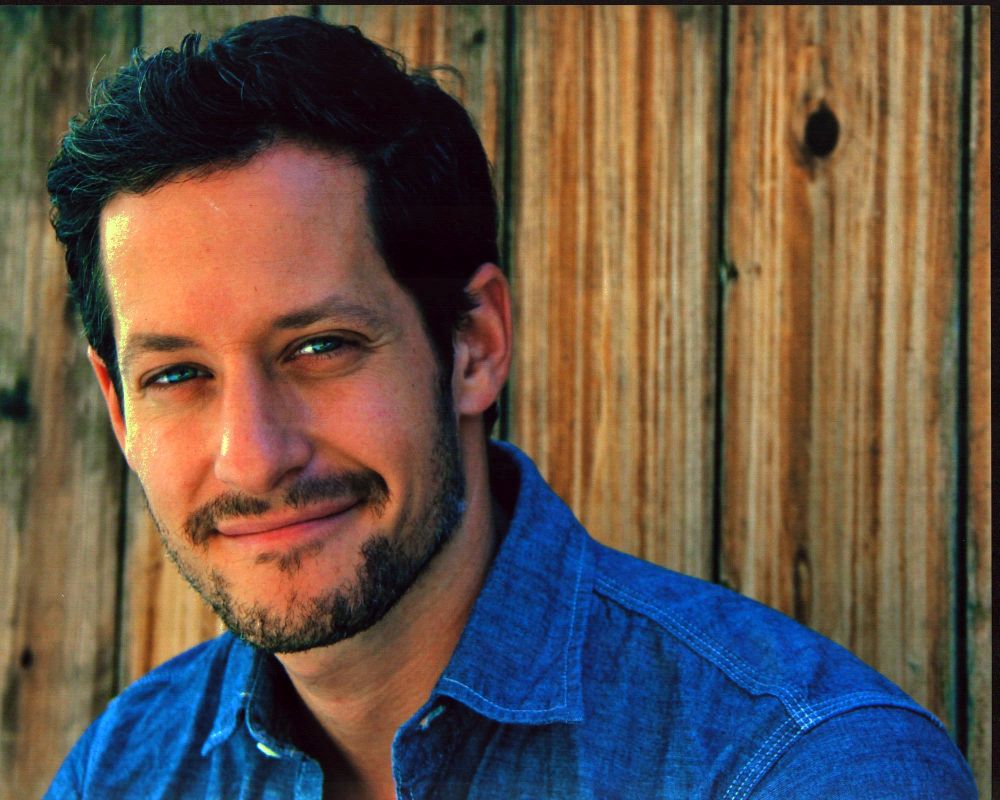 Jeremy Glazer headshot photo print in denim shirt against wood background