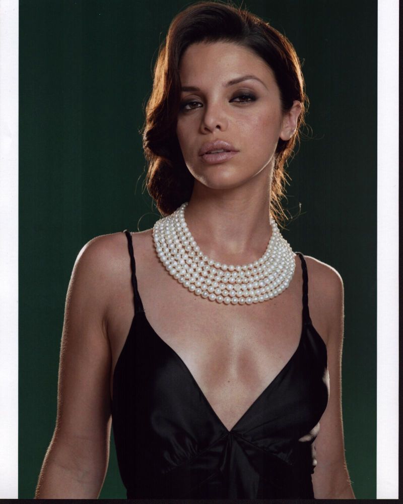 Vanessa Ferlito photo print in black top with multiple pearl necklaces.