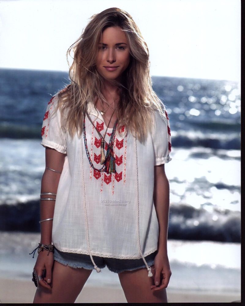 Gillian Zinser beach photo print in flowing shirt and bracelets.