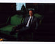 Noah Hawley seated in a suit on a green chair photo print.