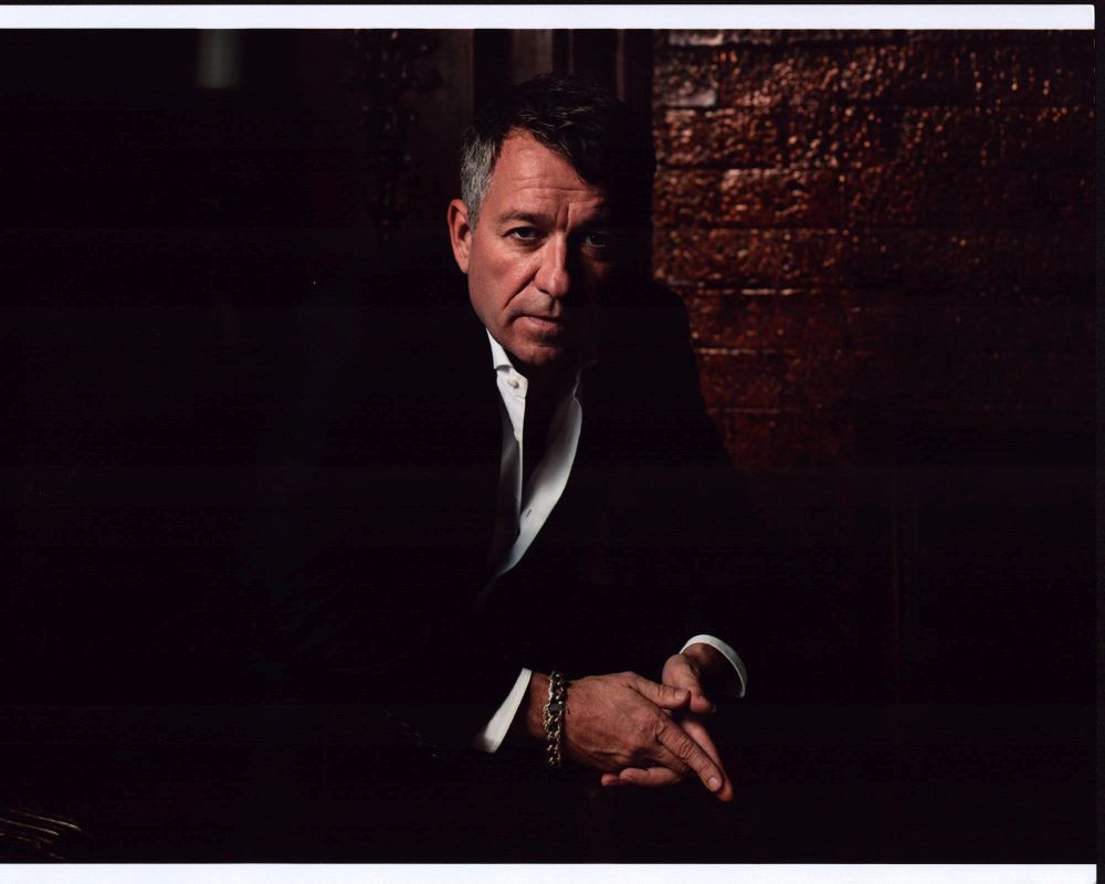 Sean Pertwee leaning forward in unbuttoned shirt photo print