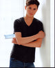 Tyler Young leaning on wall in shirt and jeans photo print
