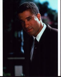 Dorian Gregory photo print on set of Charmed in a stylish suit.