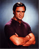 Joe Penny photo print with arms crossed in a purple shirt.