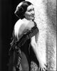 Gloria Swanson leaning against a wall in a backless dress photo print.