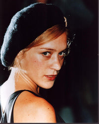 Chloë Sevigny looking over her shoulder in a black beret photo print.