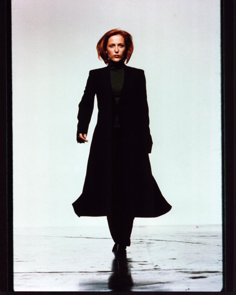 Gillian Anderson walking in long black coat photo print.