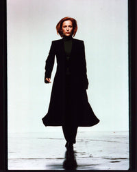 Gillian Anderson walking in long black coat photo print.