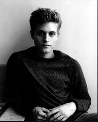 Ashley Charles leaning against wall black and white photo print.