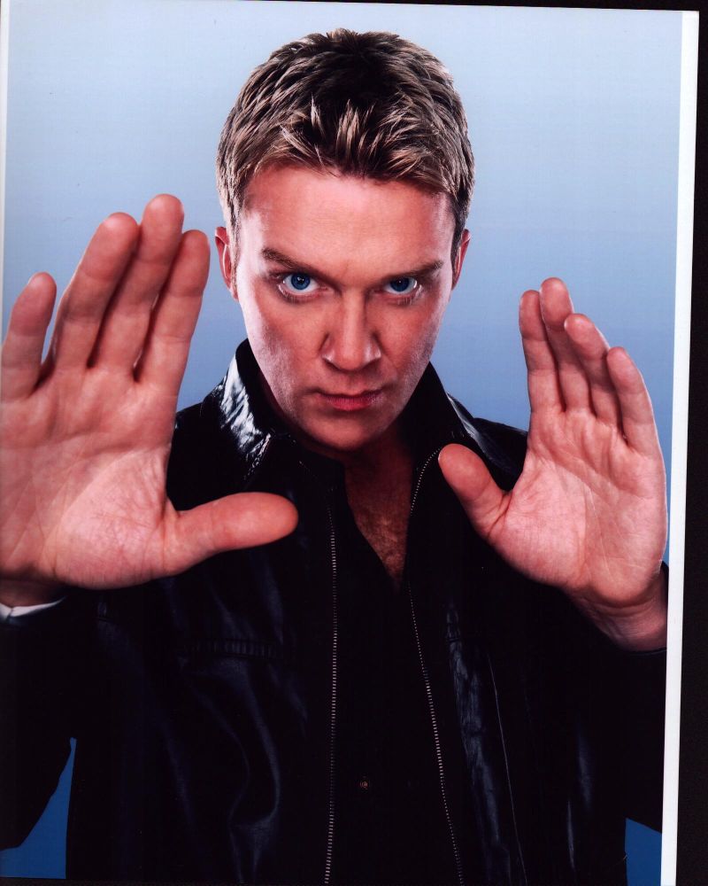 Anthony Michael Hall photo print in leather jacket with hands up.