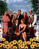 Dharma & Greg Cast with Flowers Photo Print showcasing the beloved duo surrounded by blooms.