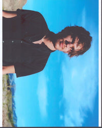Ellar Coltrane in black top photo print against desert background