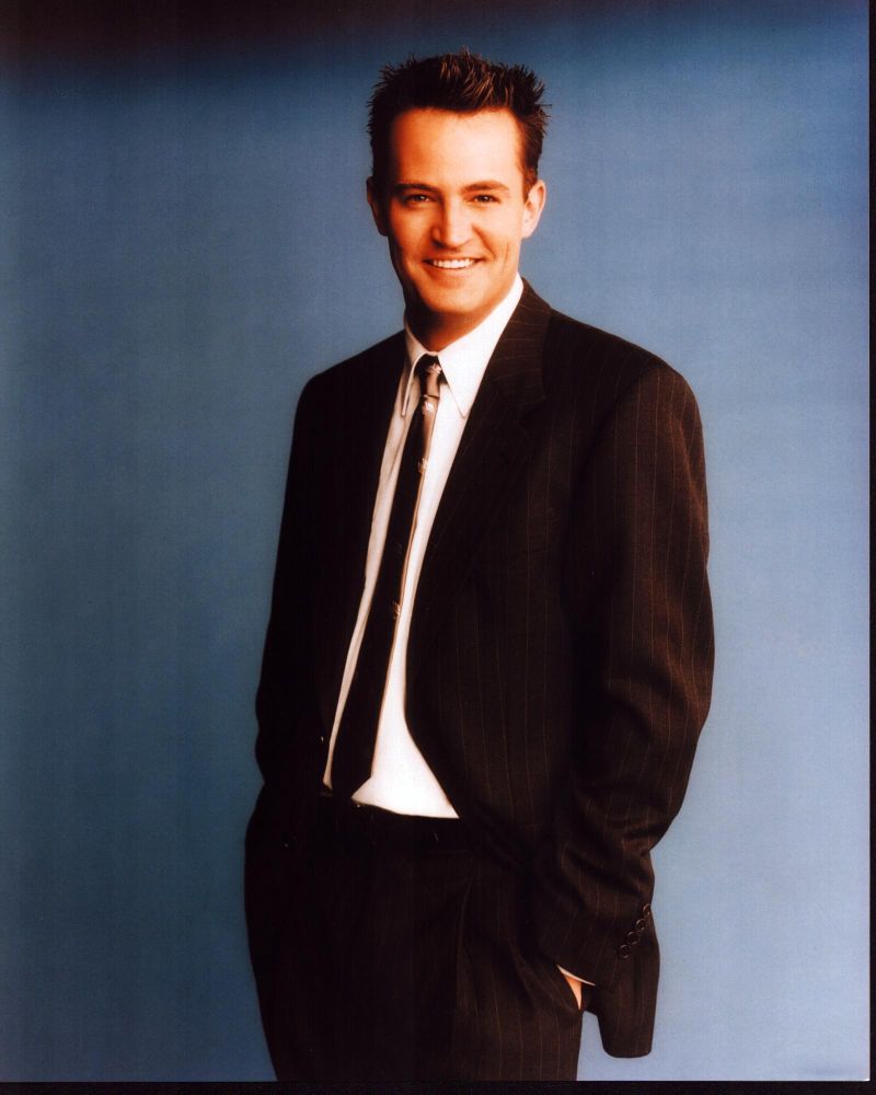Matthew Perry photo print in striped suit with hands in pockets.