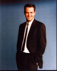 Matthew Perry photo print in striped suit with hands in pockets.