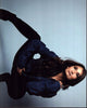 Anjali Bhimani crouched in denim jacket photo print.