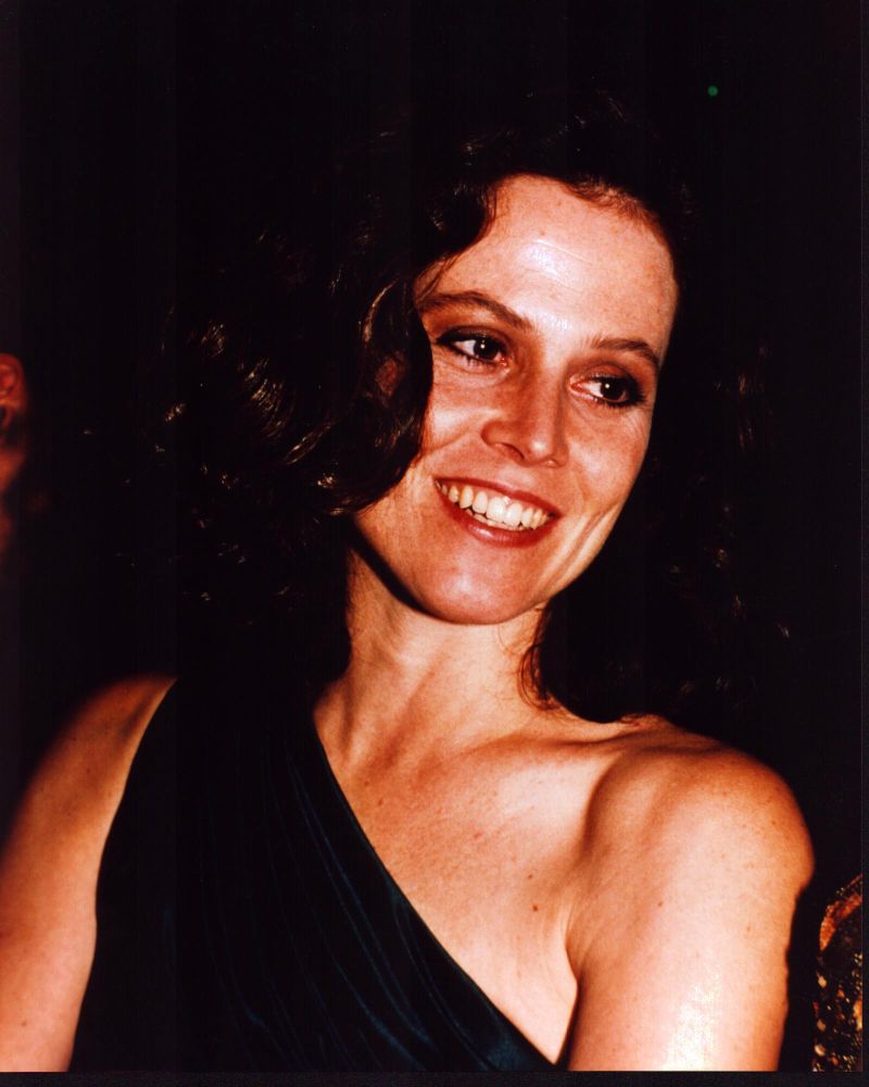 Sigourney Weaver smiling in one shoulder dress photo print.