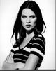 Black and white photo print of Kate Moss with arms crossed in striped shirt.