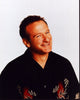 Close-up photo print of Robin Williams in black and red shirt.