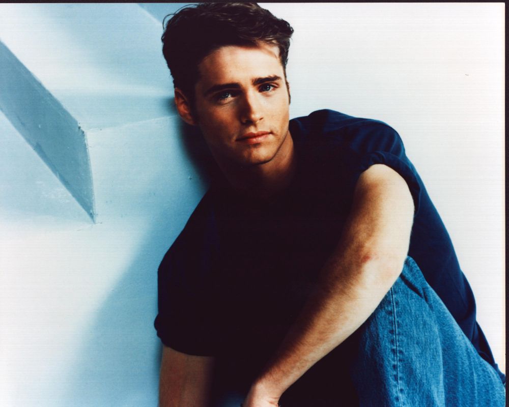 Jason Priestley sitting in jeans with knee up photo print
