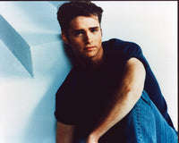 Jason Priestley sitting in jeans with knee up photo print