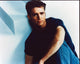 Jason Priestley sitting in jeans with knee up photo print