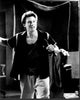 Black and white photo print of Christian Slater wearing sweatpants with a microphone.