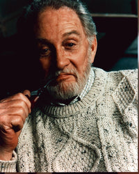 Roy Dotrice photo print in cable knit sweater with pipe.