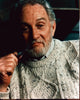 Roy Dotrice photo print in cable knit sweater with pipe.