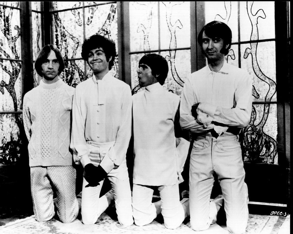 Black and white photo print of The Monkees on knees, vintage music decor.