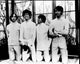 Black and white photo print of The Monkees on knees, vintage music decor.