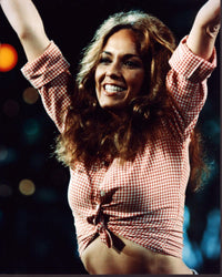 Catherine Bach arms up wearing a red plaid shirt photo print