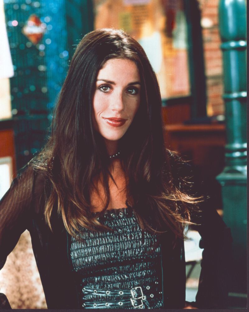 Soleil Moon Frye photo print in black leather and sheer outfit, hands on hips.