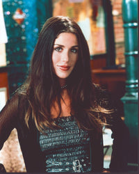 Soleil Moon Frye photo print in black leather and sheer outfit, hands on hips.