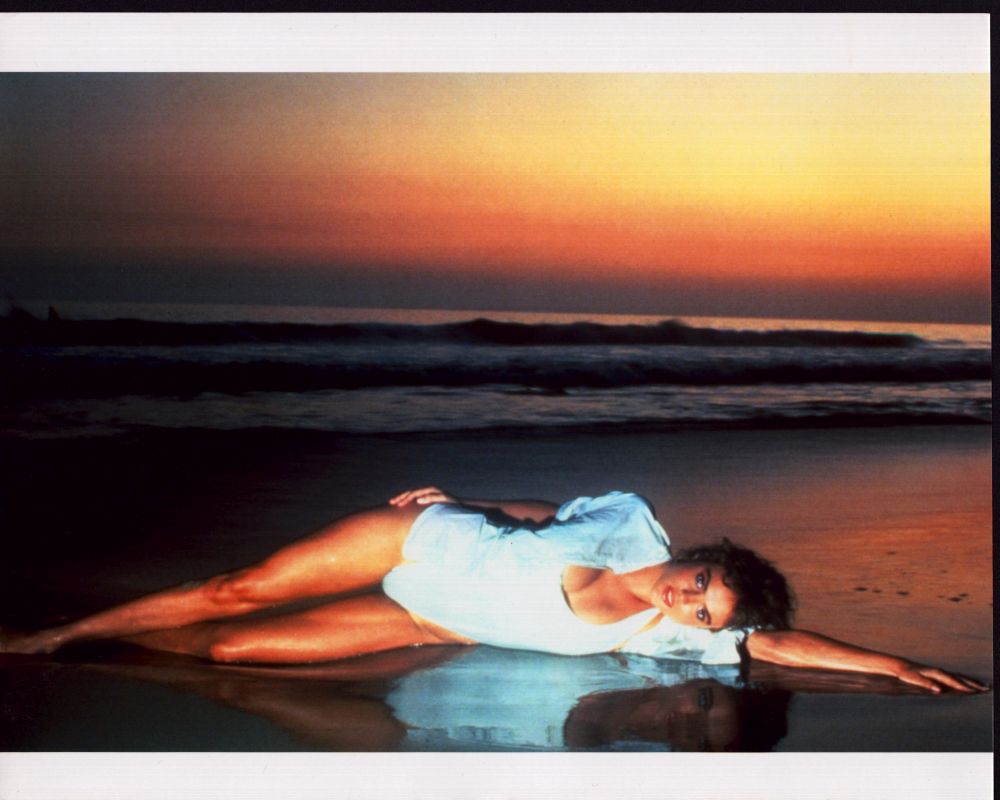 Michelle Johnson Laying on Beach Photo Print showcasing serene beach scene.