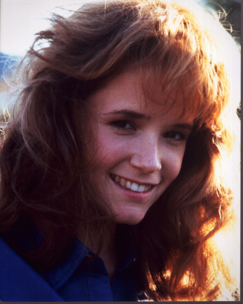 Lea Thompson smiling in blue top photo print