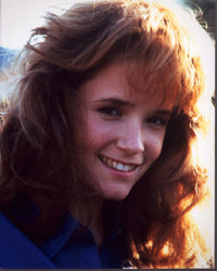 Lea Thompson smiling in blue top photo print