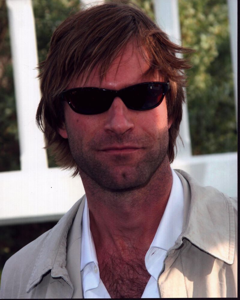 Aaron Eckhart in tan jacket and sunglasses photo print.