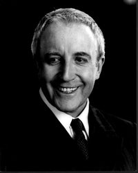 Black and white headshot photo print of Peter Sellers in a suit.