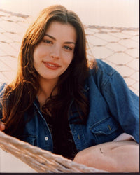 Liv Tyler in denim jacket relaxing on a hammock photo print.