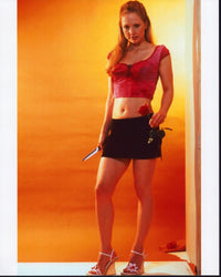 Justine Priestley holding a knife in a mini skirt photo print.