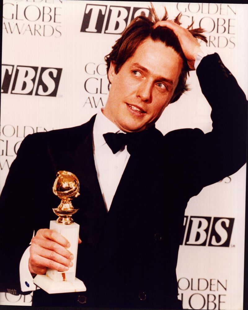 Hugh Grant holding Golden Globe Award photo print