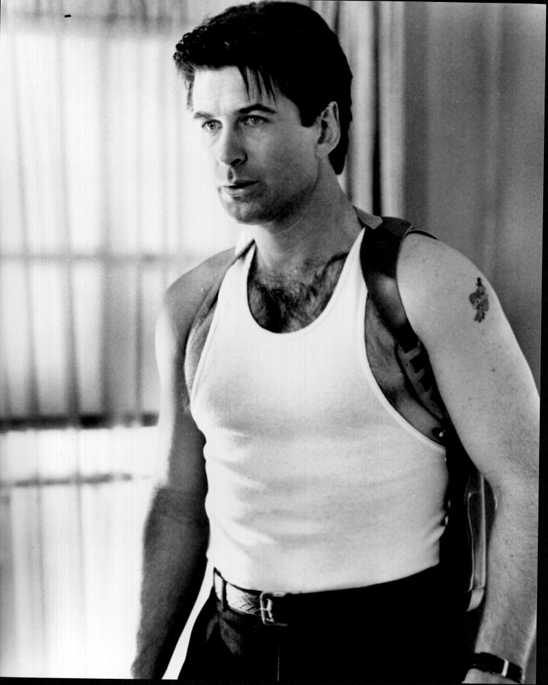 Alec Baldwin wearing a gun holster in a black and white photo print