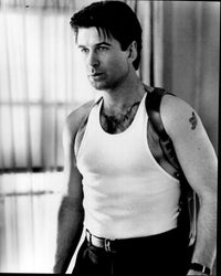 Alec Baldwin wearing a gun holster in a black and white photo print