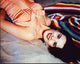 Jean Peters in an orange bathing suit laying on the sand photo print.