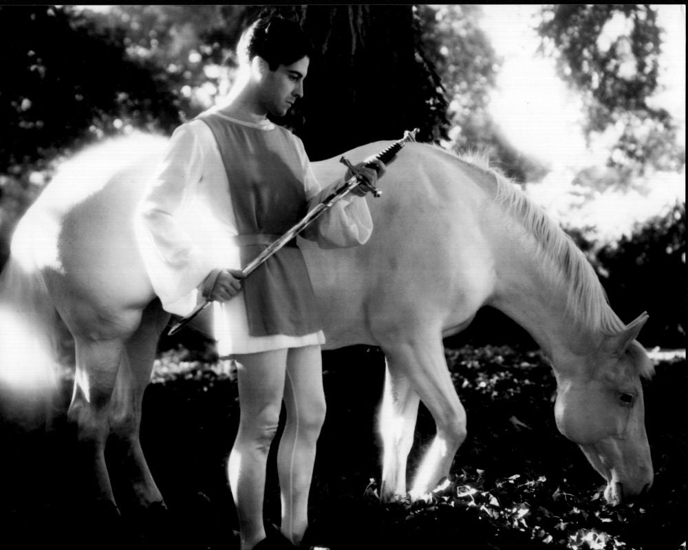 Ramon Novarro black and white photo print with sword next to horse.