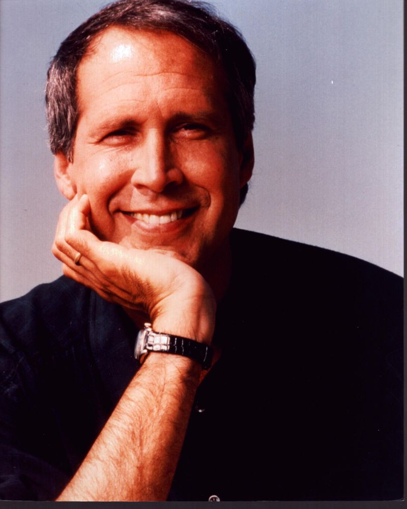 Chevy Chase smiling with head on hand photo print.