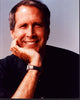 Chevy Chase smiling with head on hand photo print.
