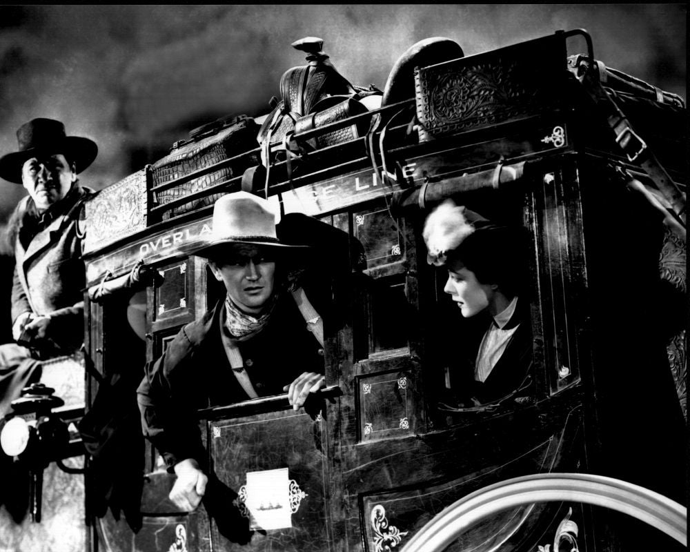 Black and white photo print of George Bancroft, John Wayne, and Louise Platt in Stagecoach
