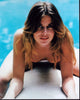 Nastassja Kinski leaning forward on surfboard photo print.