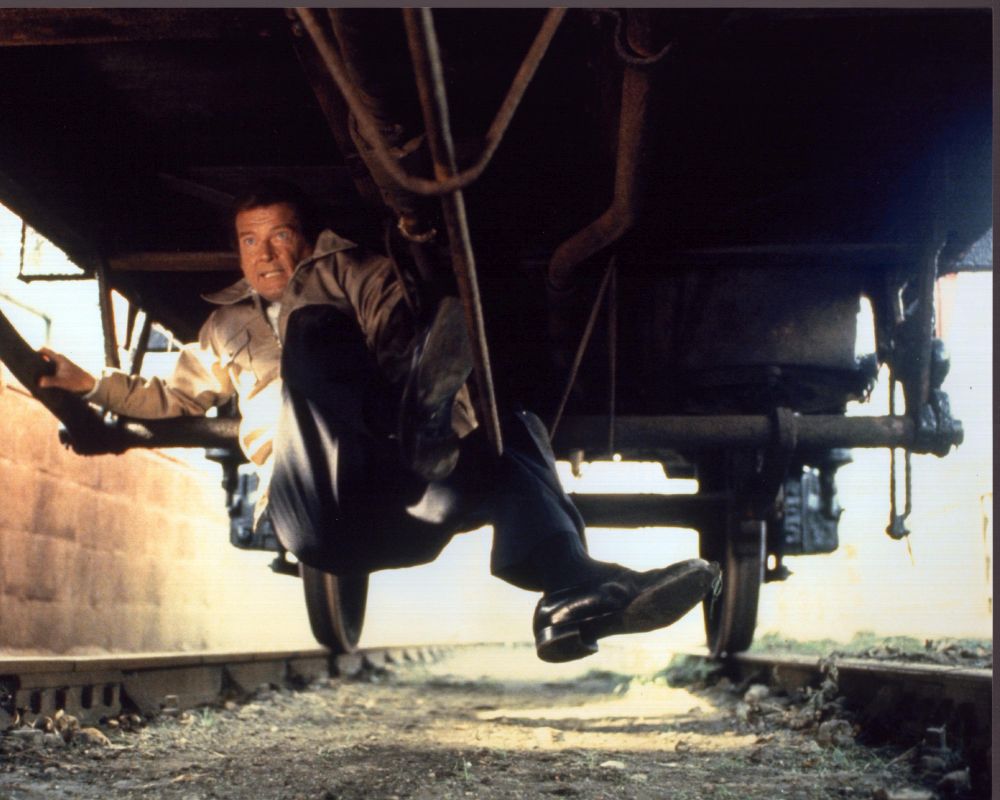 Roger Moore Under Train Car in Octopussy Photo Print